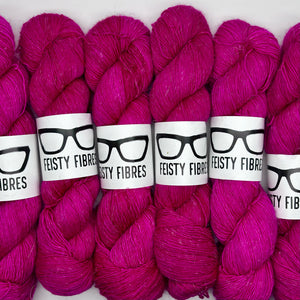 Pink Merino Linen yarn skeins with 'Feisty Fibres' labels on a white background